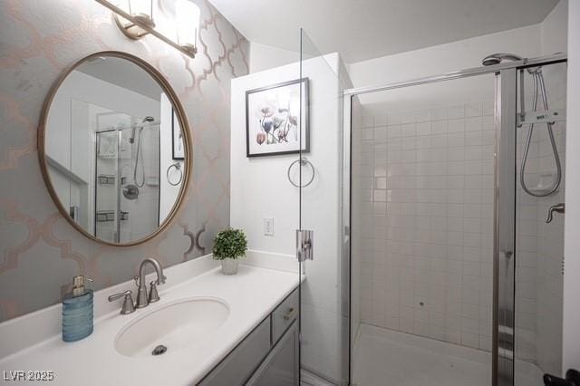 bathroom featuring vanity and a shower with shower door