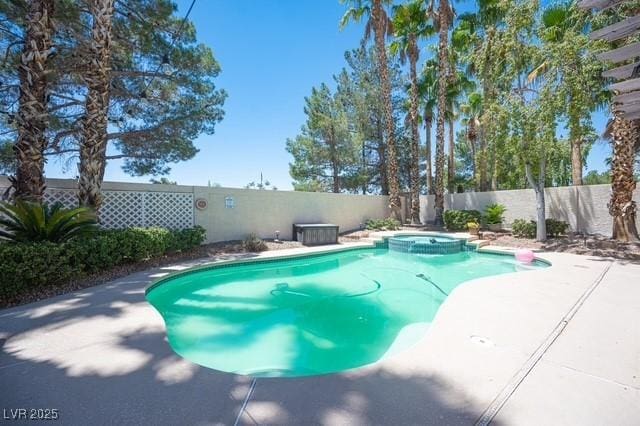 view of pool with an in ground hot tub and a patio