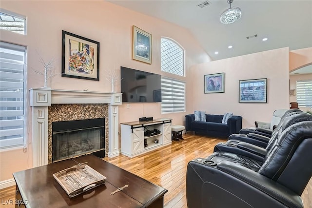 living room featuring lofted ceiling and light wood-type flooring