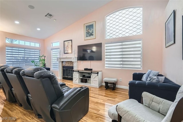 living room featuring high vaulted ceiling and light wood-type flooring