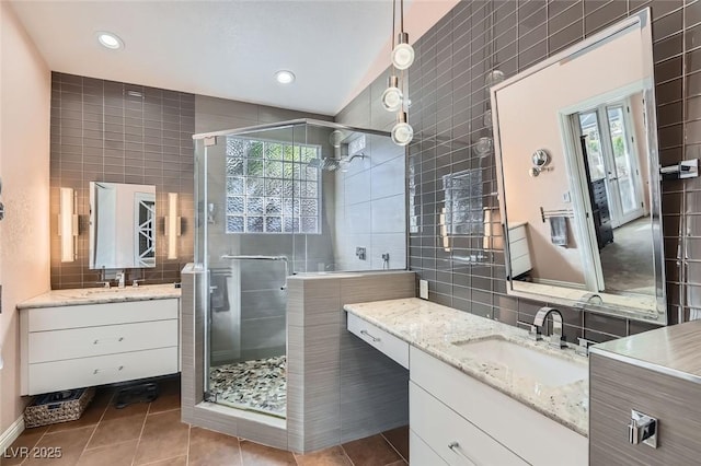 bathroom with tile walls, vanity, tile patterned floors, and an enclosed shower