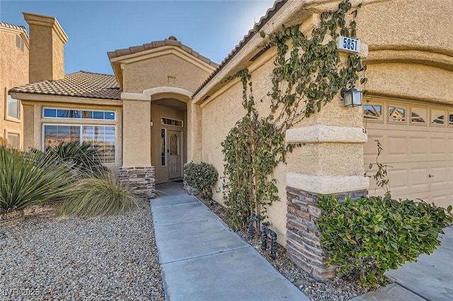 view of exterior entry featuring a garage