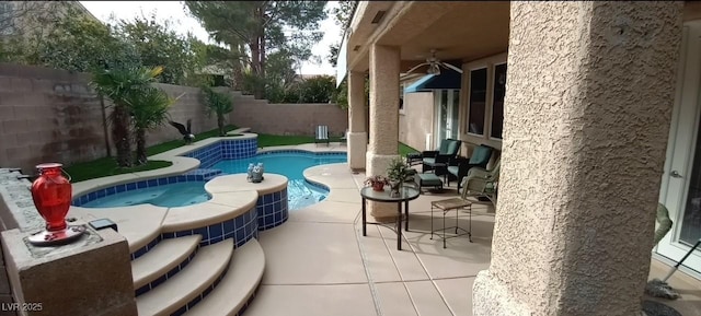 view of pool with ceiling fan and a patio area