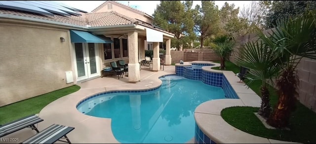 view of pool featuring an in ground hot tub and a patio