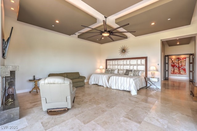 bedroom with beamed ceiling and a high end fireplace