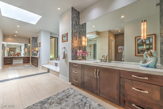 bathroom with vanity, tile patterned floors, and a skylight