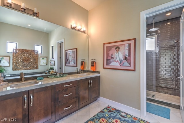 bathroom with vanity and a tile shower