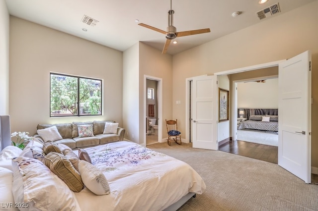 carpeted bedroom with ceiling fan and connected bathroom