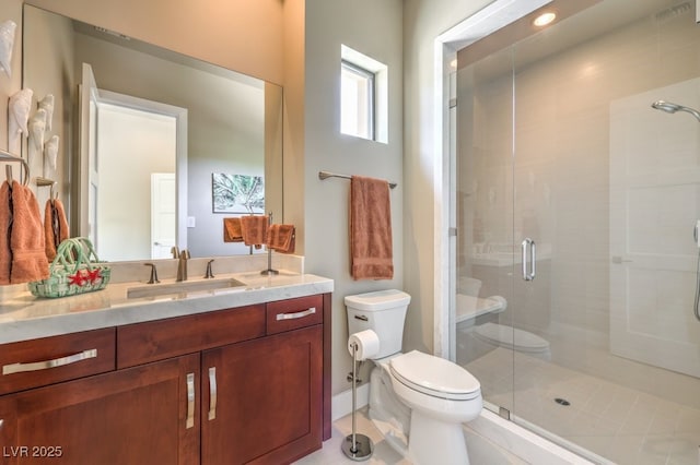 bathroom with toilet, vanity, and walk in shower