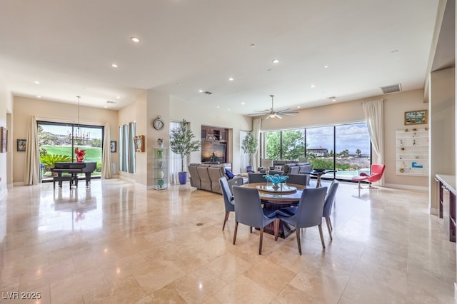 dining area with ceiling fan with notable chandelier