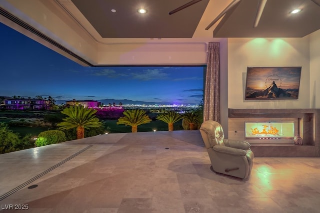 interior space featuring ceiling fan and a fireplace