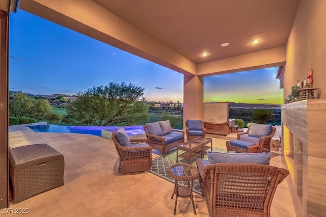 patio terrace at dusk featuring outdoor lounge area