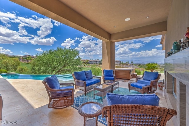 view of patio / terrace featuring a swimming pool with hot tub and an outdoor living space