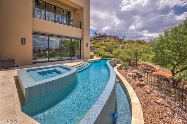 view of pool with an in ground hot tub