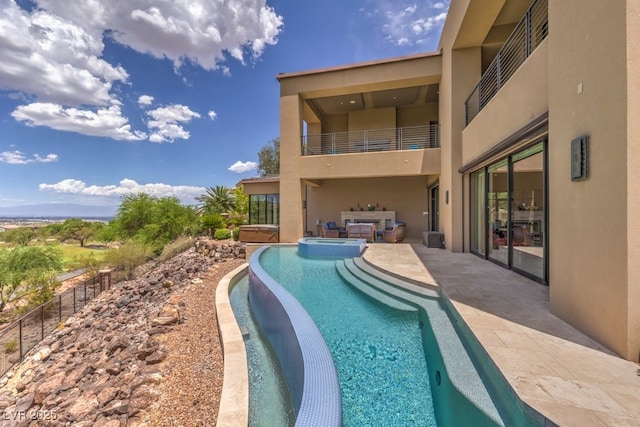 view of swimming pool featuring a patio area and an in ground hot tub