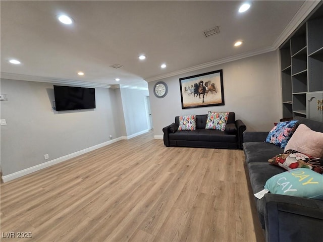 living room with light wood-type flooring, baseboards, crown molding, and recessed lighting