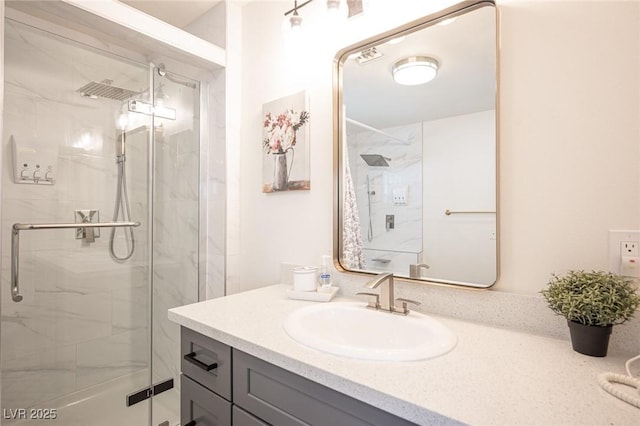 full bathroom with a marble finish shower and vanity