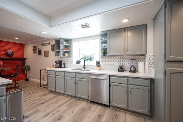 kitchen with gray cabinets, dishwasher, a sink, and open shelves