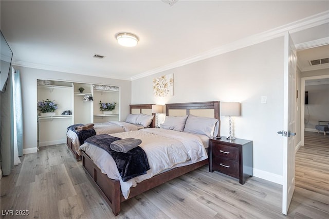 bedroom with ornamental molding, light wood-type flooring, and visible vents