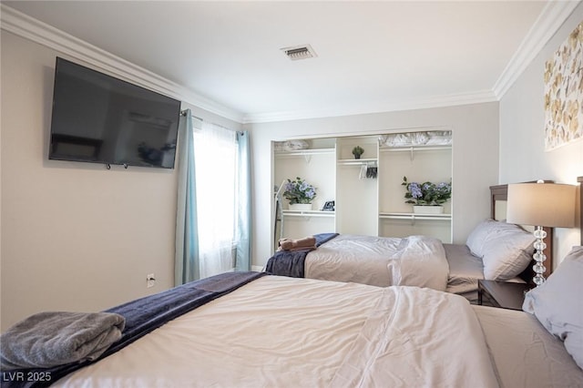 bedroom featuring a closet, visible vents, and crown molding