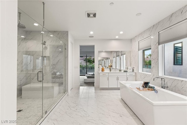 bathroom featuring vanity and separate shower and tub