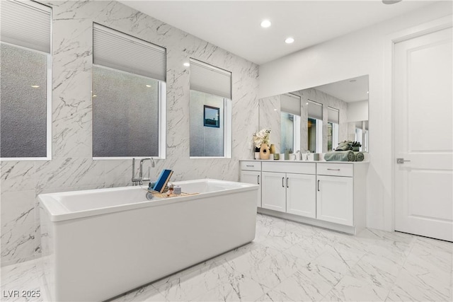 bathroom with vanity and a tub to relax in