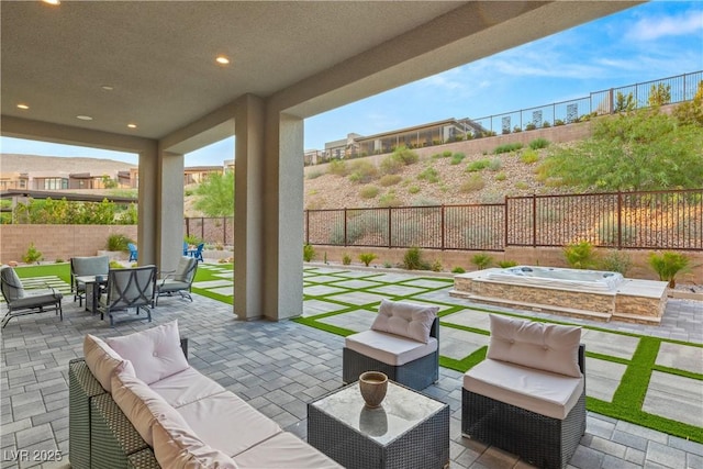 view of patio with an outdoor hangout area and a hot tub