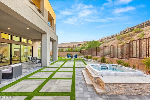 view of pool featuring an outdoor hot tub, a mountain view, and a patio