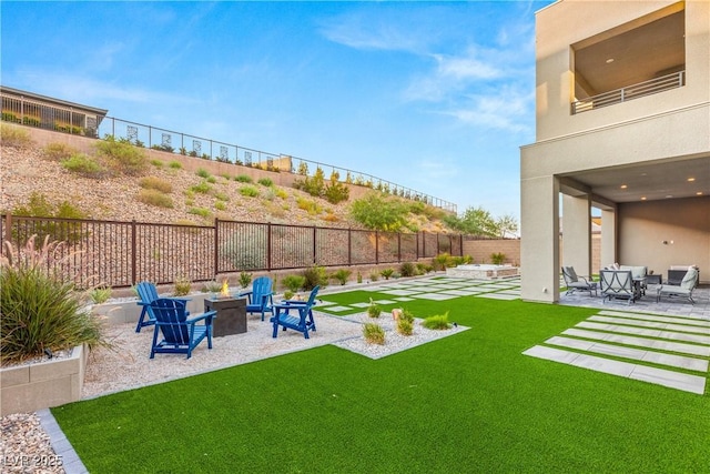 view of yard with an outdoor fire pit and a patio