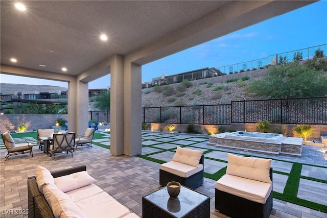 view of patio / terrace featuring an outdoor hangout area and an outdoor hot tub