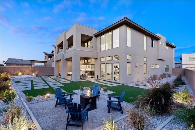 back of house with a patio area, central air condition unit, and an outdoor fire pit