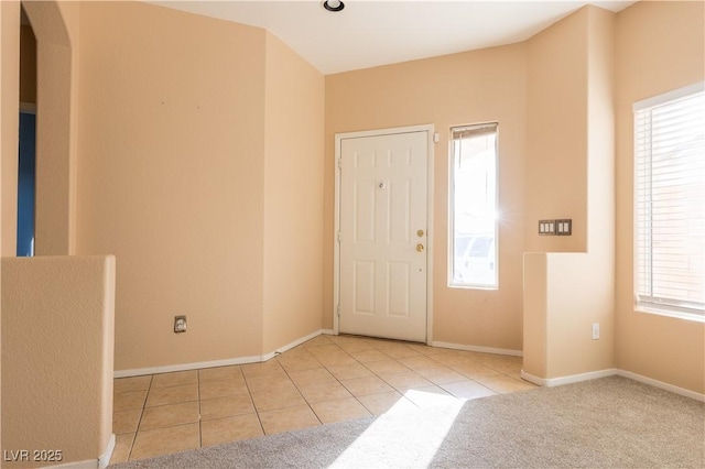 tiled entryway with a healthy amount of sunlight