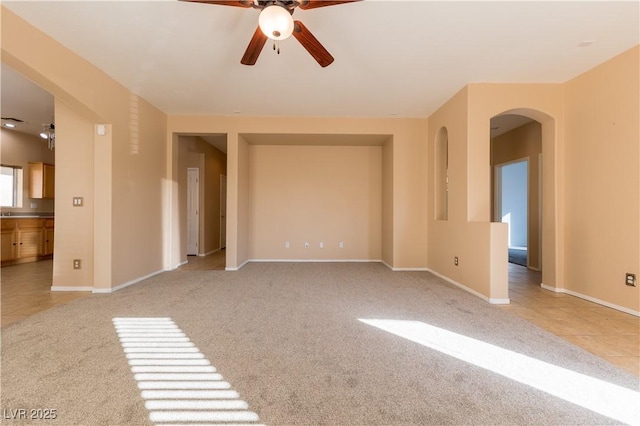 empty room with light colored carpet and ceiling fan