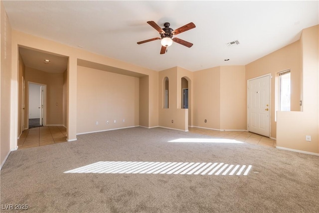 unfurnished room with light colored carpet and ceiling fan