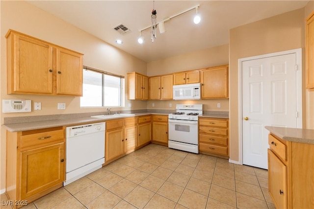 kitchen with white appliances, light tile patterned floors, sink, and light brown cabinets