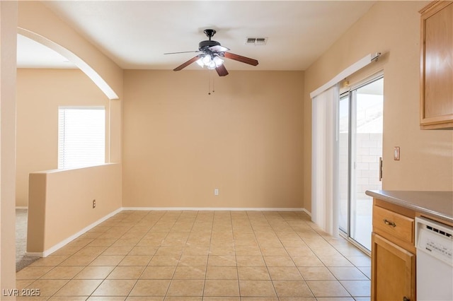 interior space featuring white dishwasher, light brown cabinets, ceiling fan, and light tile patterned flooring