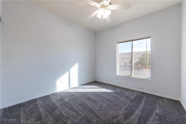 unfurnished room featuring ceiling fan and dark colored carpet