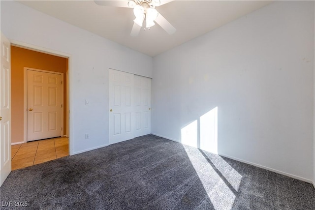 unfurnished bedroom with ceiling fan and carpet