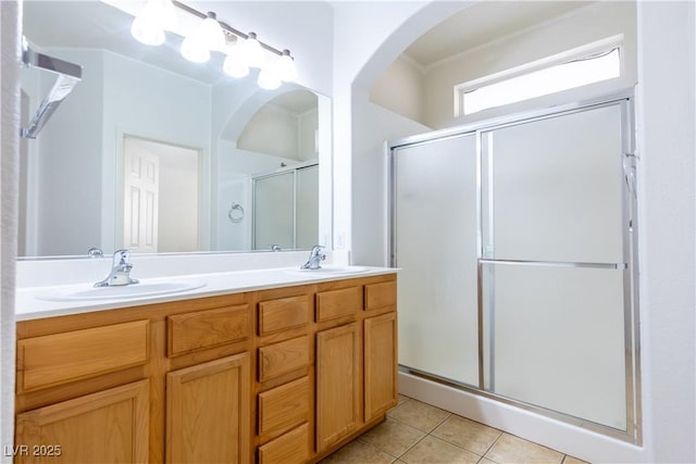 bathroom with tile patterned flooring, vanity, and an enclosed shower