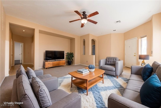 carpeted living room featuring ceiling fan