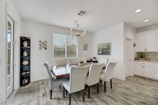 dining room with a chandelier and light hardwood / wood-style floors