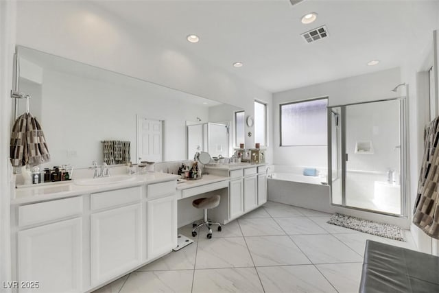 bathroom with vanity and independent shower and bath