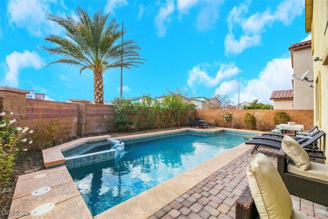 view of pool with a patio area and an in ground hot tub