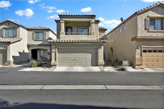 mediterranean / spanish house featuring a garage, a balcony, and central AC