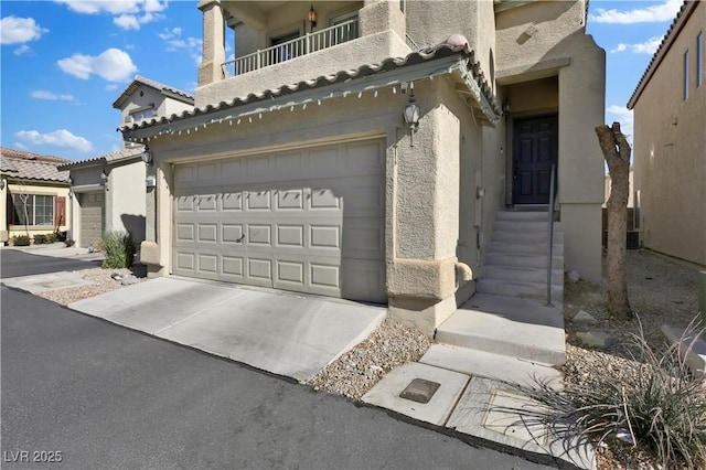 view of front of home with a garage and a balcony