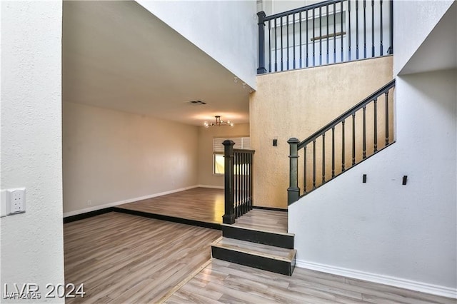 interior space featuring a high ceiling and hardwood / wood-style floors