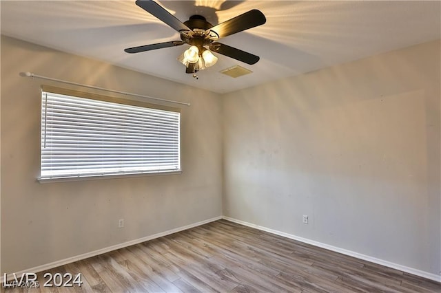 unfurnished room featuring hardwood / wood-style flooring, a healthy amount of sunlight, and ceiling fan