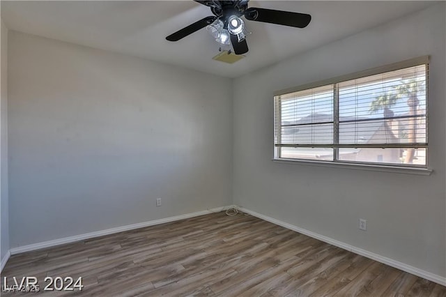 empty room featuring hardwood / wood-style floors and ceiling fan