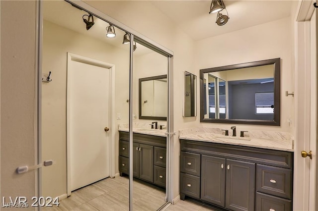 bathroom with vanity and track lighting