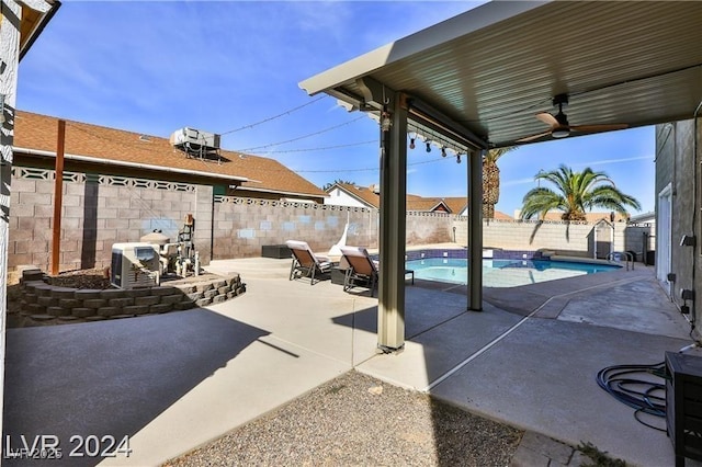 view of patio with ceiling fan and a fenced in pool